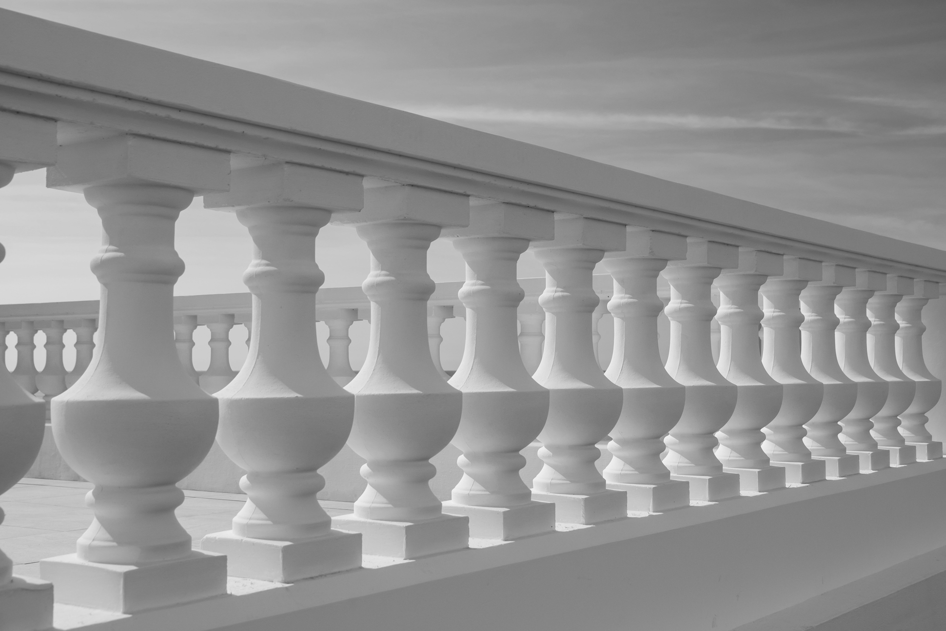 Private equity fund hero image of decorative stone pillar wall with black and white filter